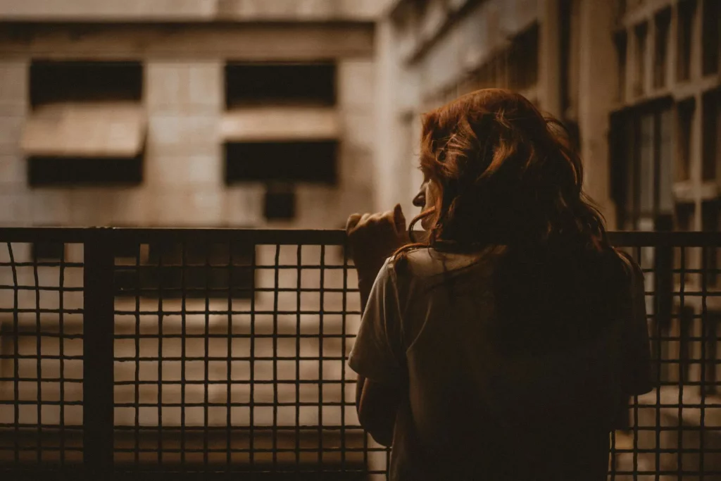 New expat sitting alone in a Berlin apartment, facing the emotional and bureaucratic challenges of relocation.